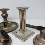 A George V candlestick, in the form of a column, Sheffield 1910, a capstan inkwell, two napkin