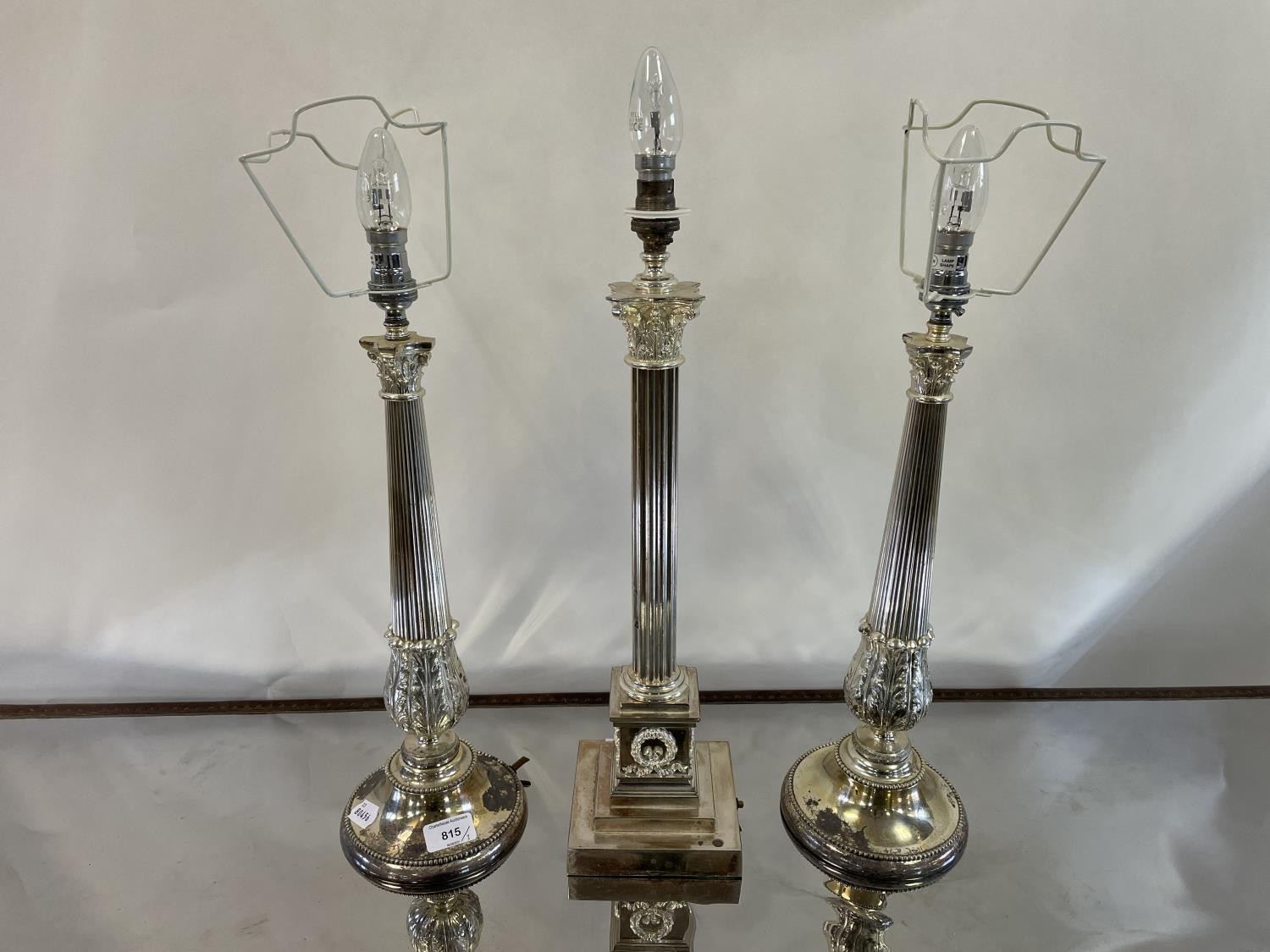 A pair of silver plated table lamp bases, in the form of Corinthian columns, 41 cm high and another,