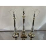 A pair of silver plated table lamp bases, in the form of Corinthian columns, 41 cm high and another,