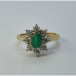 A 9ct gold, emerald and diamond cluster ring, ring size K Oval cut emerald 0.43ct approx. Diamonds