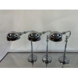 A set of three adjustable chrome and glass table lamps, by Andrew Martin, 51 cm high (2) The wire