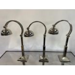 A set of three chrome adjustable table lamps, 69 cm high (3) The wire has been cut off and will need