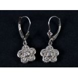 A pair of 10ct white gold and diamond flowerhead drop earrings