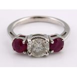 An 18ct white gold, ruby and diamond three stone ring, ring size K Stone weight approx. 1.5ct