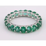 A 14ct white gold emerald full eternity ring, ring size M Total carat weight 4.06ct approx.