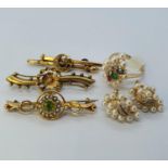 An early 20th century 9ct gold peridot and seed pearl bar brooch, two bar brooches, a dress ring and