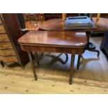 A 19th century mahogany folding tea table, on turned tapering legs, 91 cm wide