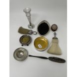 A silver and satinwood bottle coaster, a tea strainer, a photograph frame, various other items,