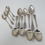 A pair of George III silver old English pattern serving spoons, three other serving spoons, four