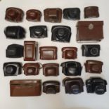 A Kodak leather camera case, various other camera cases, a mid 20th century photograph album, mostly