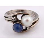 A 14ct white gold, cultured pearl and cabochon sapphire crossover ring, set two diamonds, ring