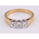 An 18ct gold three stone diamond ring, ring size M 1/2 Diamond weight 1.00ct approx.