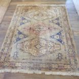 A Persian type cream ground carpet, with multiple borders and three central stepped medallions,