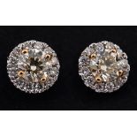 A pair of 18ct white gold and yellow diamond halo stud earrings Diamond weight 0.52ct approx.