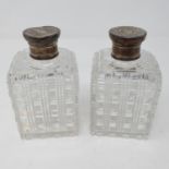 A pair of Edward VII cut glass bottles, with silver tops, Asprey, London 1902, 12 cm high (2)