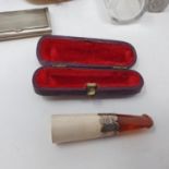 A 19th century amber and bone cigar holder, in fitted leather case, a carved Indian pot, and other