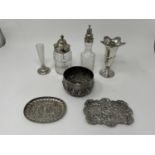 An Indian silver bowl, decorated figures and beasts, two silver pin trays, a posy vase, two cut