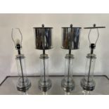 A set of four chrome and glass table lamps, 42 cm high