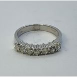 An 18ct white gold and seven stone diamond ring, ring size L 1/2 Diamonds 0.052ct approx. with