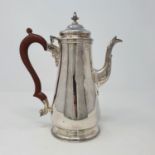 A silver coffee pot, with a carved wooden handle, London 1964, 17 ozt