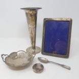 A silver posy vase, base filled, a silver photograph frame, a bottle top, a bonbon dish and a