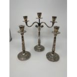 A pair of silver candlesticks, 27 cm high and a matching two branch candelabra, 35 cm high,