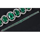An 18ct white gold, graduated emerald and diamond cluster bracelet Emerald weight 7.86ct approx.