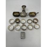 A George V silver egg cup, a matchbox holder, ten napkin rings, and a three piece cruet, various