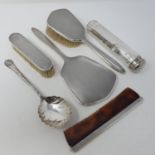 A silver hand mirror, Birmingham 1968, two matching brushes, a comb with silver mount, a serving