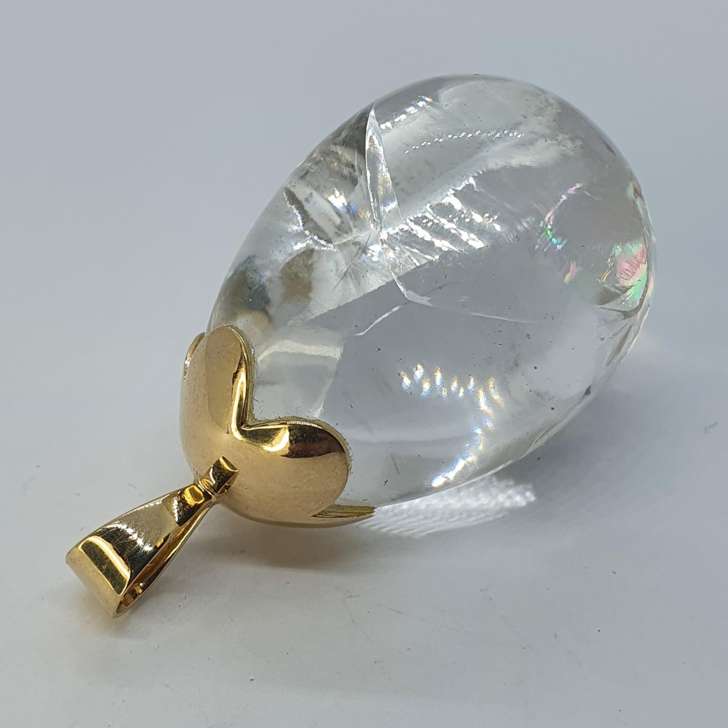 A pear shaped rock crystal pendant, with a yellow coloured metal suspension, 5.5 cm high Flawed/