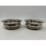 A pair of silver and mahogany bottle coasters, 12.5 cm diameter (2) Marks rubbed