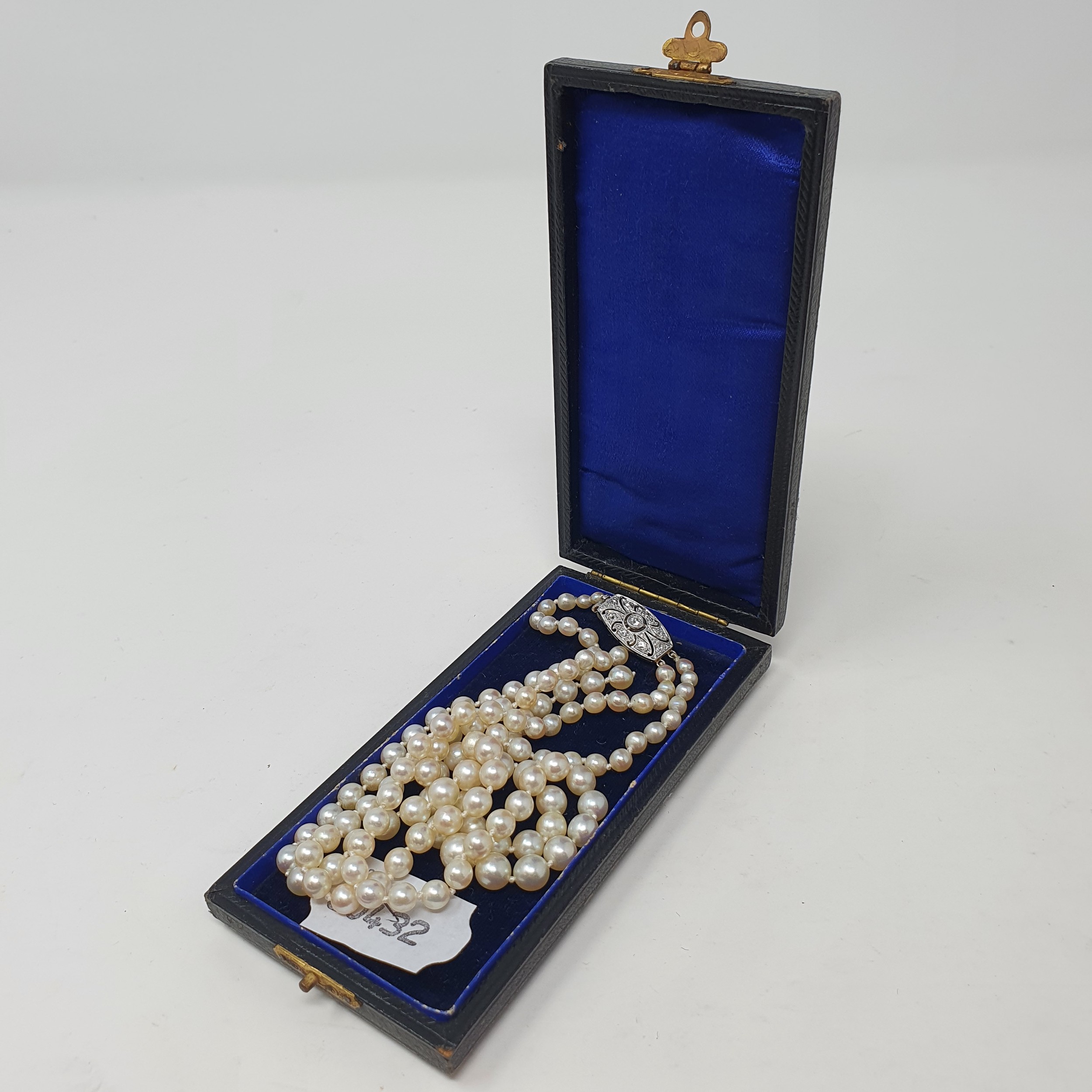 A two row cultured pearl necklace, with a diamond set clasp, boxed One strand broken