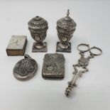 A pair of Victorian silver tongs, Birmingham 1881, two pepper pots, a matchbox holder, a vesta and