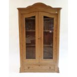 A Continental pine cabinet, having two plain doors above a single drawer, 119 cm high x 112 cm