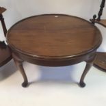 A Waring & Gillow mahogany coffee table, labeled thereto, 79 cm diameter, and two whatnots (3)