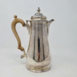 A silver hot water jug, with a carved wooden handle, London 1963, 16.6 ozt