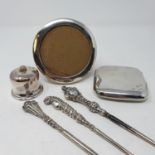 A George V silver cigarette case, Birmingham 1923, a photograph frame, two spoons, three button