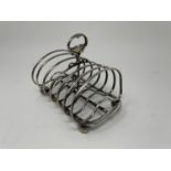 A Victorian silver toast rack, London 1851, 11.9 ozt slightly out of shape,
