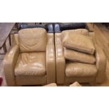 A pair of leather armchairs (2) and two spare back cushions