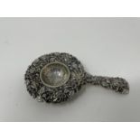 A Chinese silver coloured metal tea strainer, decorated blossom See images