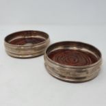 A pair of silver and mahogany bottle coasters, London 2000 (2)