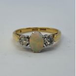 An 18ct gold, opal and diamond ring, ring size L 1/2