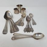 A set of six George III old English pattern desert spoons, 14 teaspoons and three napkin rings, 16.5