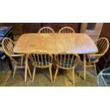 An Ercol light elm extending dining table, and six matching hoop back chairs (7) top 152 cm x 82