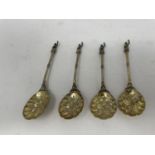 A set of Continental silver coloured metal and silver gilt berry spoons, with figural finials 6 ozt
