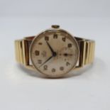 A gentleman's 9ct gold Smiths Deluxe wristwatch, with Arabic numerals and a subsidiary seconds dial,