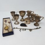 A pair of silver trophy cups, Birmingham 1938, 6 cm high, two other trophy cups, a napkin ring,