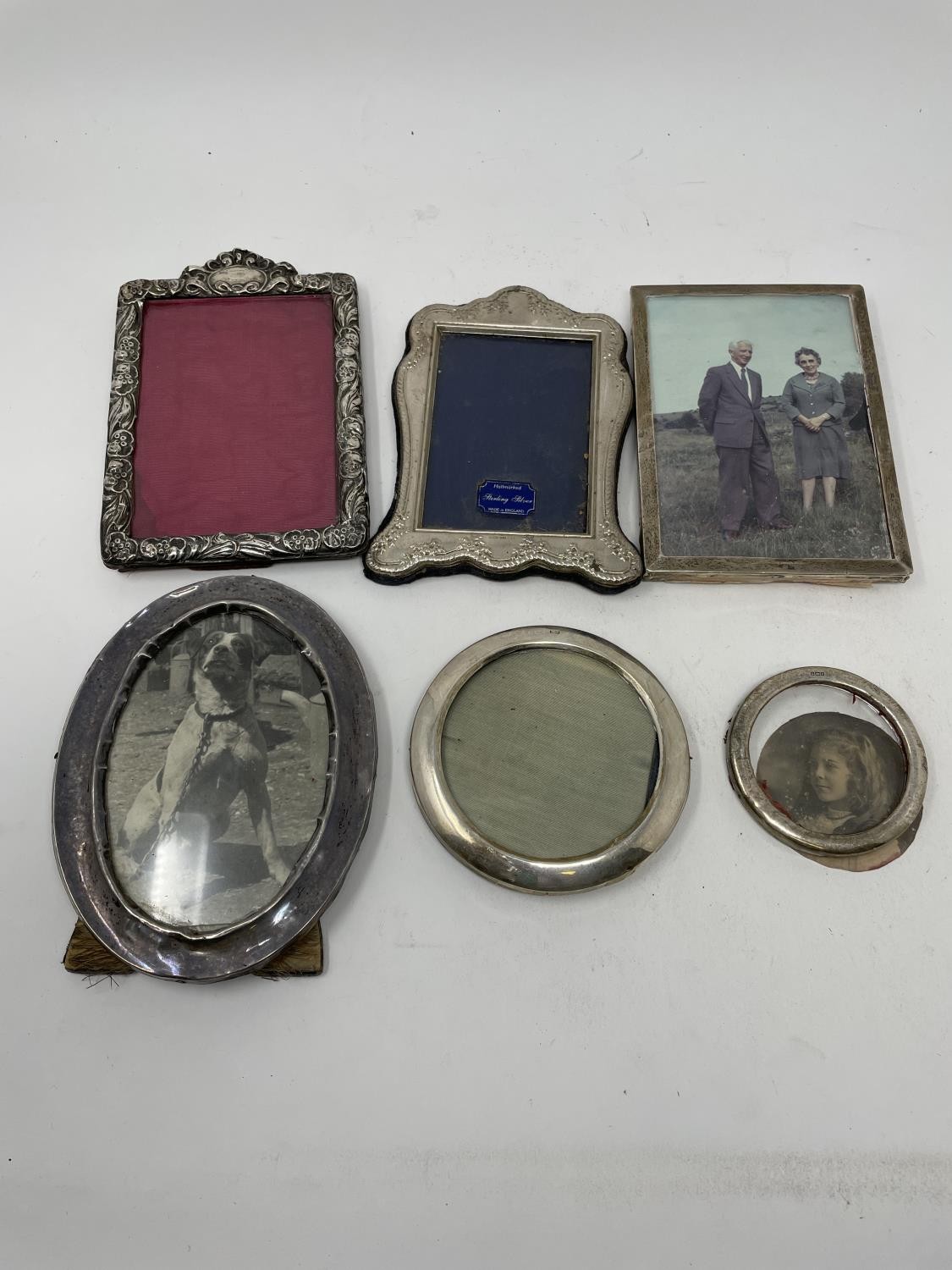 An Edward VII silver photograph frame, Birmingham 1900, and five other silver photograph frames,