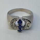 A white gold, sapphire and diamond ring, in a pierced setting, ring size M