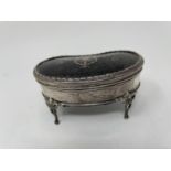 A silver kidney shaped dressing table box, with tortoiseshell top, 12 cm wide Marks rubbed,